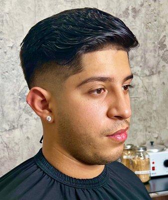 Mid low skin fade with longer hair on top