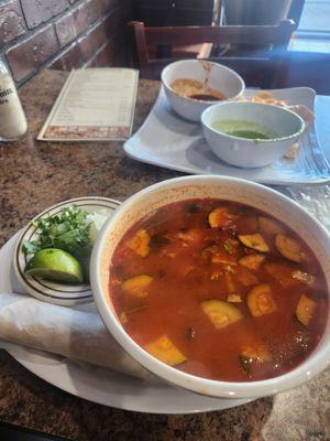 Spicy chicken soup served with Tortillas and cilantro onions and lime.