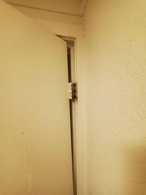 The door hinge is so busted it pulls out of the wall when you try to shut it.