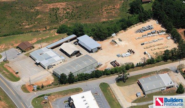 Building materials supplier Builders FirstSource's forklift is moving wood roof trusses.