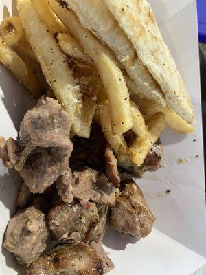 Pork chunks, fries and pita bread.