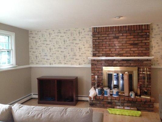 Fresh paint and an accent wall of wallpaper enhanced this basement family room for these brand new home owners