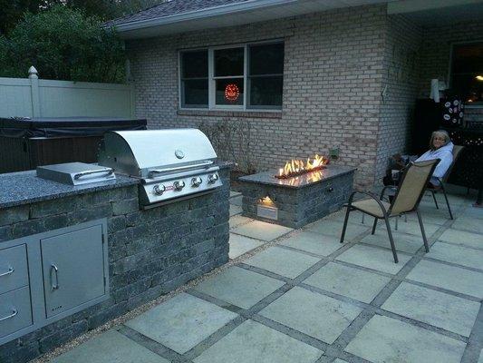 Outdoor kitchen, gas fire pit, and patio.