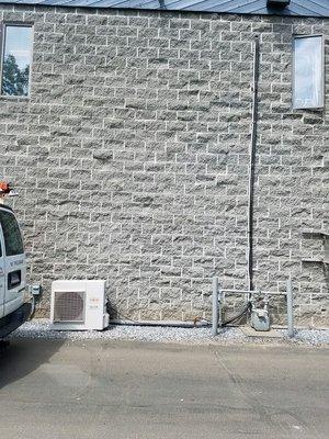 Outdoor portion of split ductless system in a local business office.