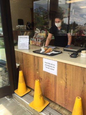 Set up with a walk-up counter. Ice cream served on trays to keep limited contact.