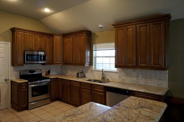 New York Glaze kitchen cabinets; Yellow Moon granite countertops; undermount kitchen sink