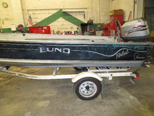 repaired and refinished the blue on the sides of this boat and made replica stripes