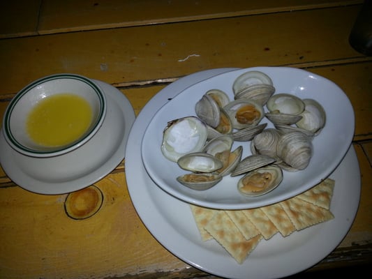 Steamed clams with unfiltered butter. They taste a lot better than they look. The price seems to be .50 cents a clam.