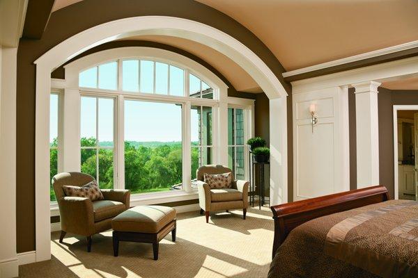 Arch top windows and transom windows open up a view.