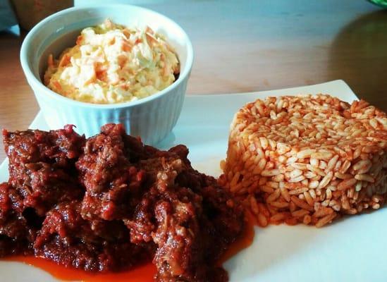 Jollof rice, beef stew and coleslaw