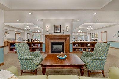 Cozy foyer gathering area in front of fireplace.