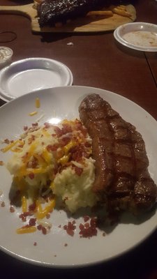 14 oz sirlon steak and mashed potatoes toped with cheese  and bacon.