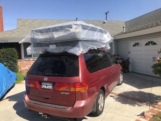 Mattress set on top of van.