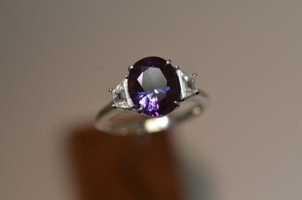 Custom made 3.02 cts. Madagascar Sapphire with trapazoid diamonds on either side set into .950 Platinum