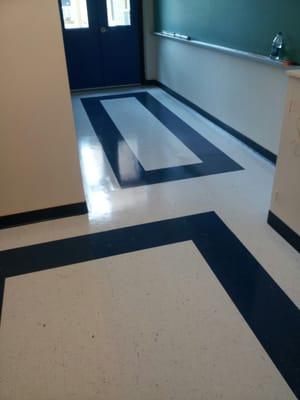 custom design of vct tile in a back hall in a school