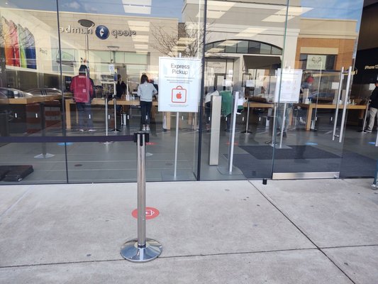 Apple store showing group of people in third kiosk