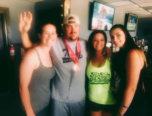 JB's Lady bartenders posing with an honored guest mid Poker Run to support Special Olympics