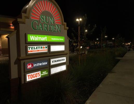 SUN GARDEN CENTER entrance sign + background mayhem