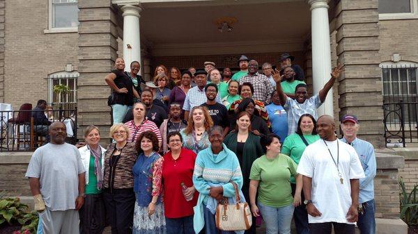 Group of Pathway Clubhouse members and staff stood on the porch outside the Clubhouse.