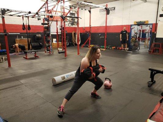 My client Maira doing lateral lunges with a sandbag.