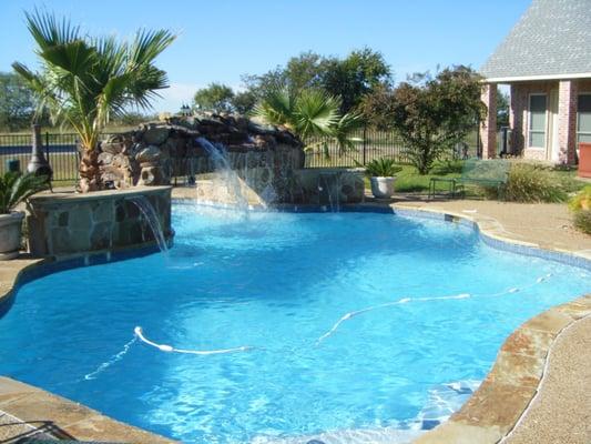 Volleyball pool with waterfall and tanning ledge