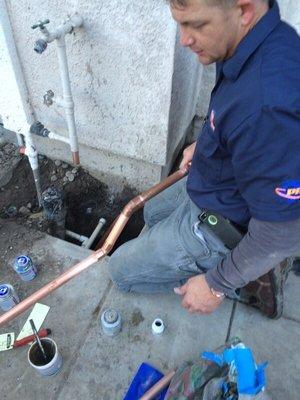 One of our Master Plumbers Dan repairing a water line.