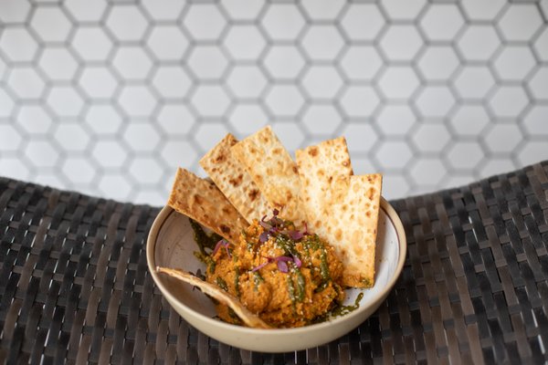 Carrot Hummus, drizzled with house chermoula and served with crispy lavash