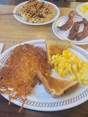 Chocolate chip waffle, cheese eggs, toast, bacon.