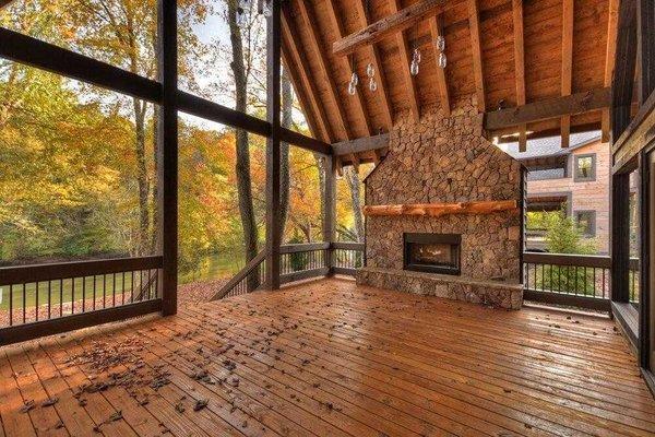 Enjoy the outdoors from the outdoor living spaces such as this covered porch with outdoor fireplace.