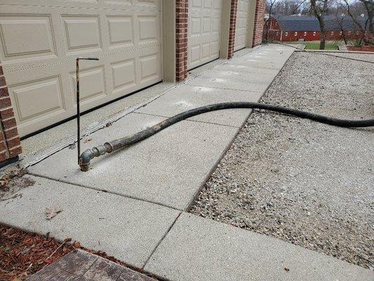 Raising a driveway apron that settled about 4" from the garage floor