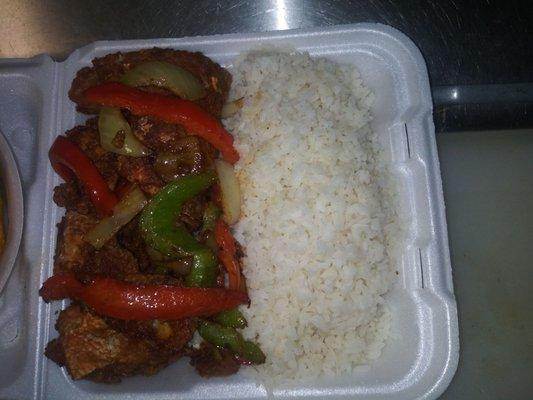 Fish dinner red snapper with peppers over white rice red. Sauce beans