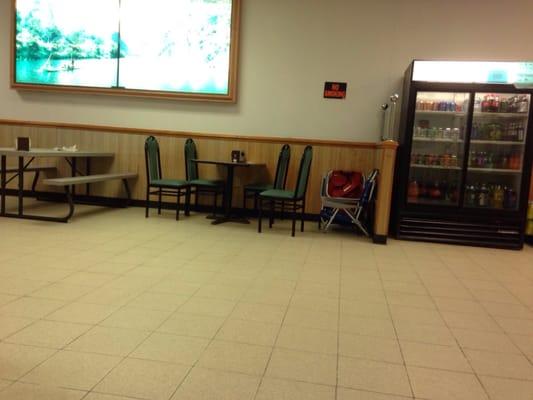 The only regular table. All of the other tables indoors are picnic tables