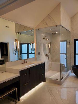 Beautiful Euro steam shower, with lux gold hardware and custom cut mirror