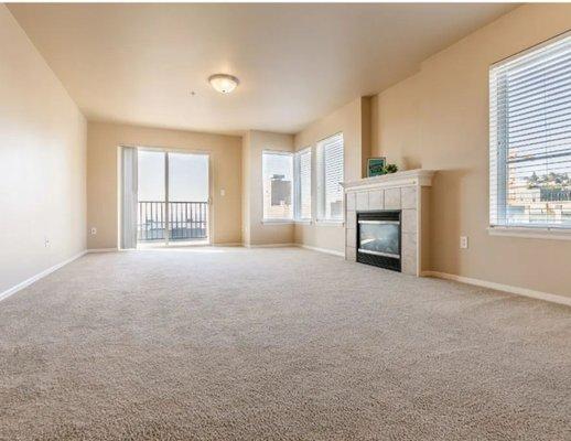 Gorgeous large living room with bay windows and electric fireplace!