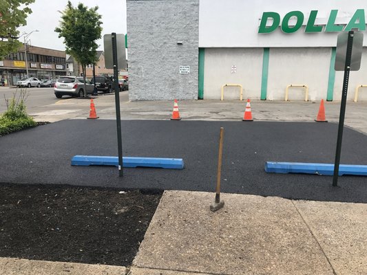 Parking lot repair. 
New asphalt installed, two parking bumpers and new handicap cap signs.