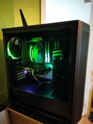 A black PC with clear window showing green RGB lighting and fans