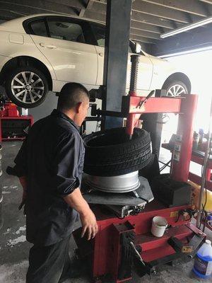 Technician installing new tire.