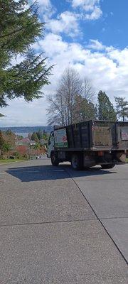 Side shot of truck and drunk landscaper pulling the truck into the oncoming lane to yell slurs and pick fights with pedestrians.