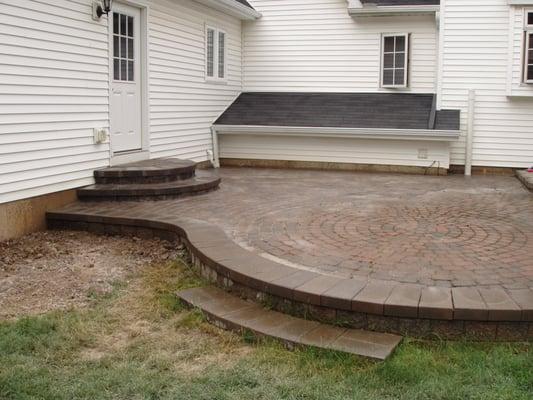 unilock patio repair with new half moon stairs off entry door