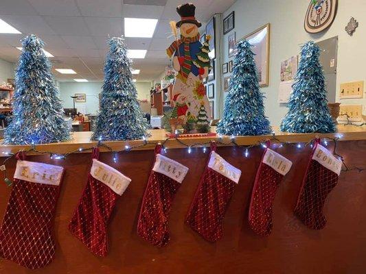 Our stockings are hung on the reception desk with care in hopes that St Nick will fill them up with tax deductible items.