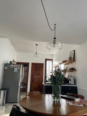 Swag pendant light over dining table and straight hang in kitchen area