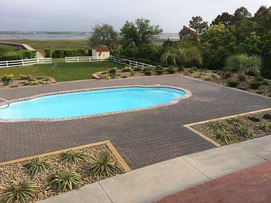 Hardscape and landscaping of this beautiful waterfront pool.  Call Task Contracting today for your landscaping needs.