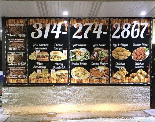 Made-to-order food is advertised on an outside wall.