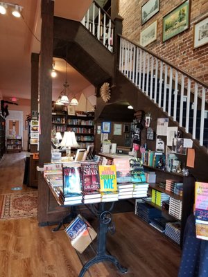 Popular books and stairway to upper portion of store.