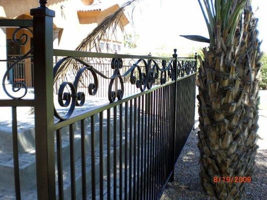 Close up of scroll work integrated into fence.