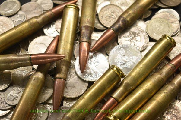 .50 BMG cartridges and silver coins