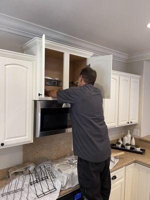 Dave is correcting an issue with the microwave vent. He even took his shop vac and made sure the vent was clear of any debris.