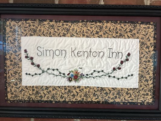 A hand embroidered work of art made for the inn by a guest.