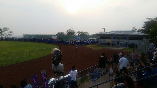 Graduates entering the football field