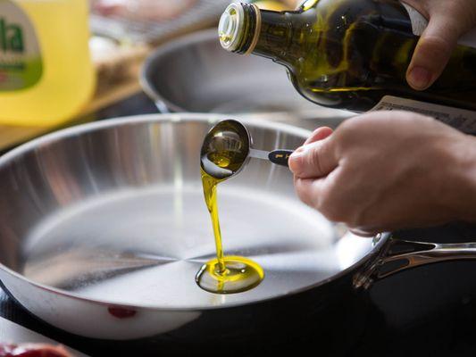 Cooking with Extra Virgin Olive Oil Typically can be heated to around 450 degrees with out burning.